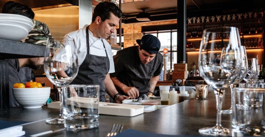 Bar Origin Toronto chef Claudio Aprile plating shareable dishes in his new restaurant dining room