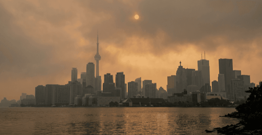 Toronto air quality under a hazy orange sky from wildfire smoke over the GTA skyline